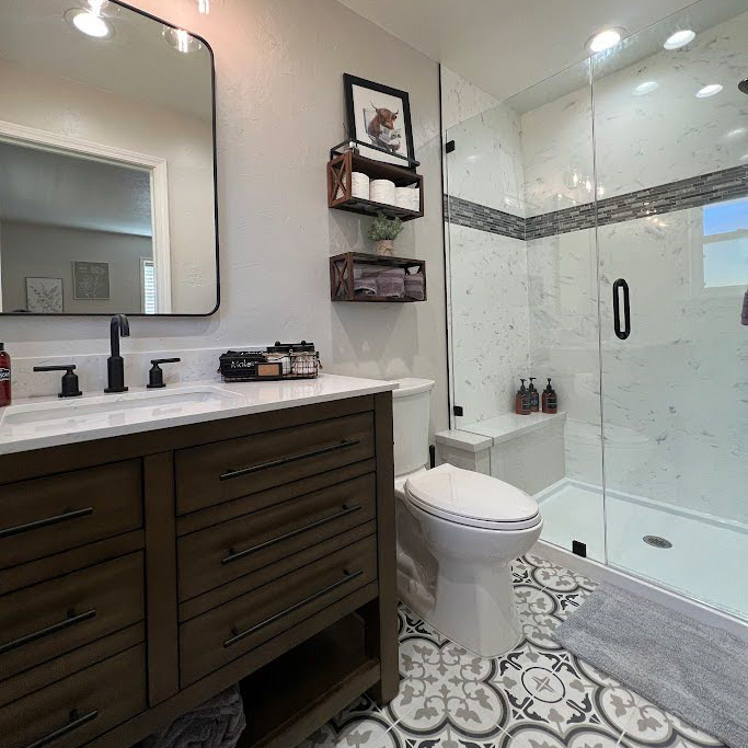 Modern full bathroom remodel in Newport Beach with a freestanding soaking tub, wood-style vanity, and custom tile work by CALbath Renovations.