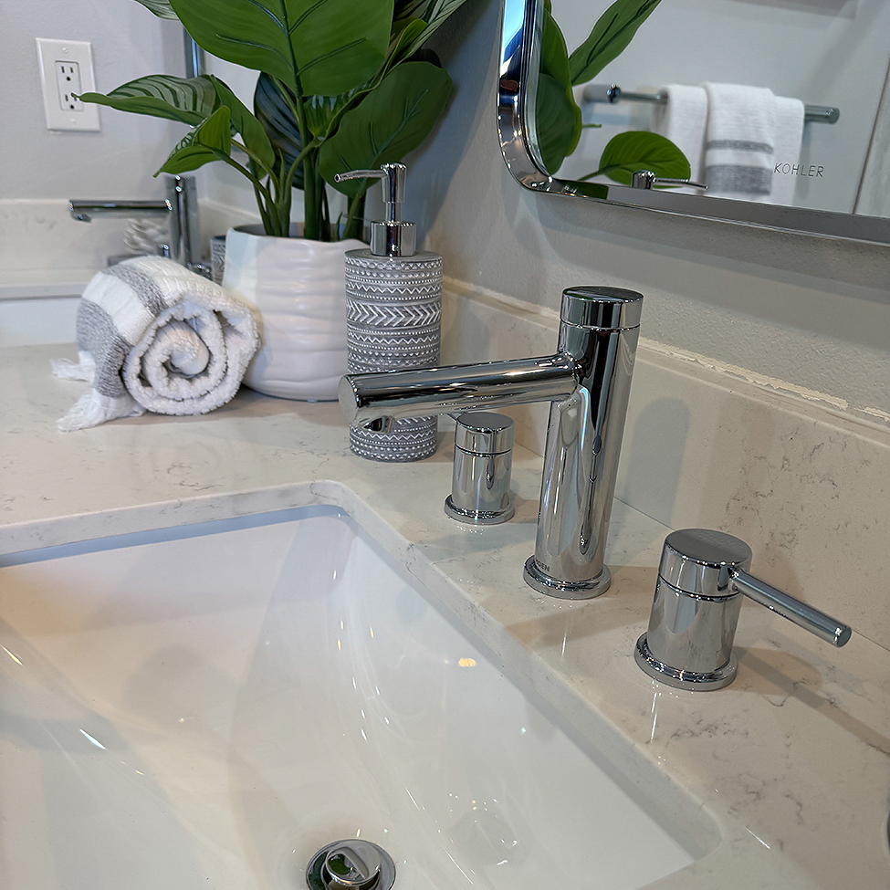 A stunning full bathroom remodel in Oceanside, CA, by CALbath Renovations, featuring a floating double vanity, quartz countertops, and a spacious walk-in shower.