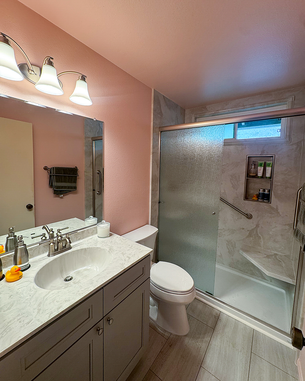 Modern full bathroom remodel in Oceanside with a freestanding soaking tub, wood-style vanity, and custom tile work by CALbath Renovations.