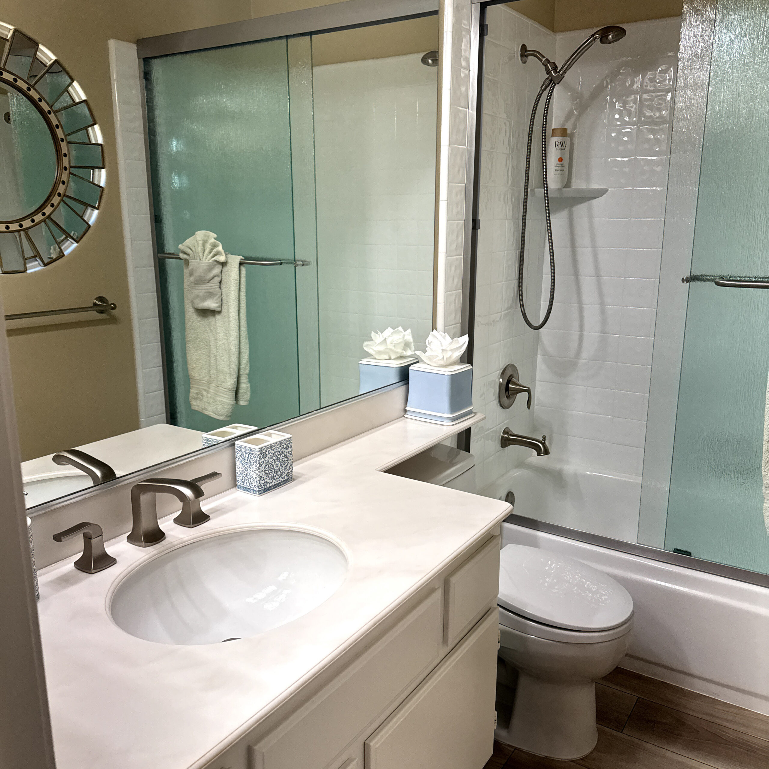 Close-up of upgraded shower fixtures and handheld sprayer in an Escondido shower remodel