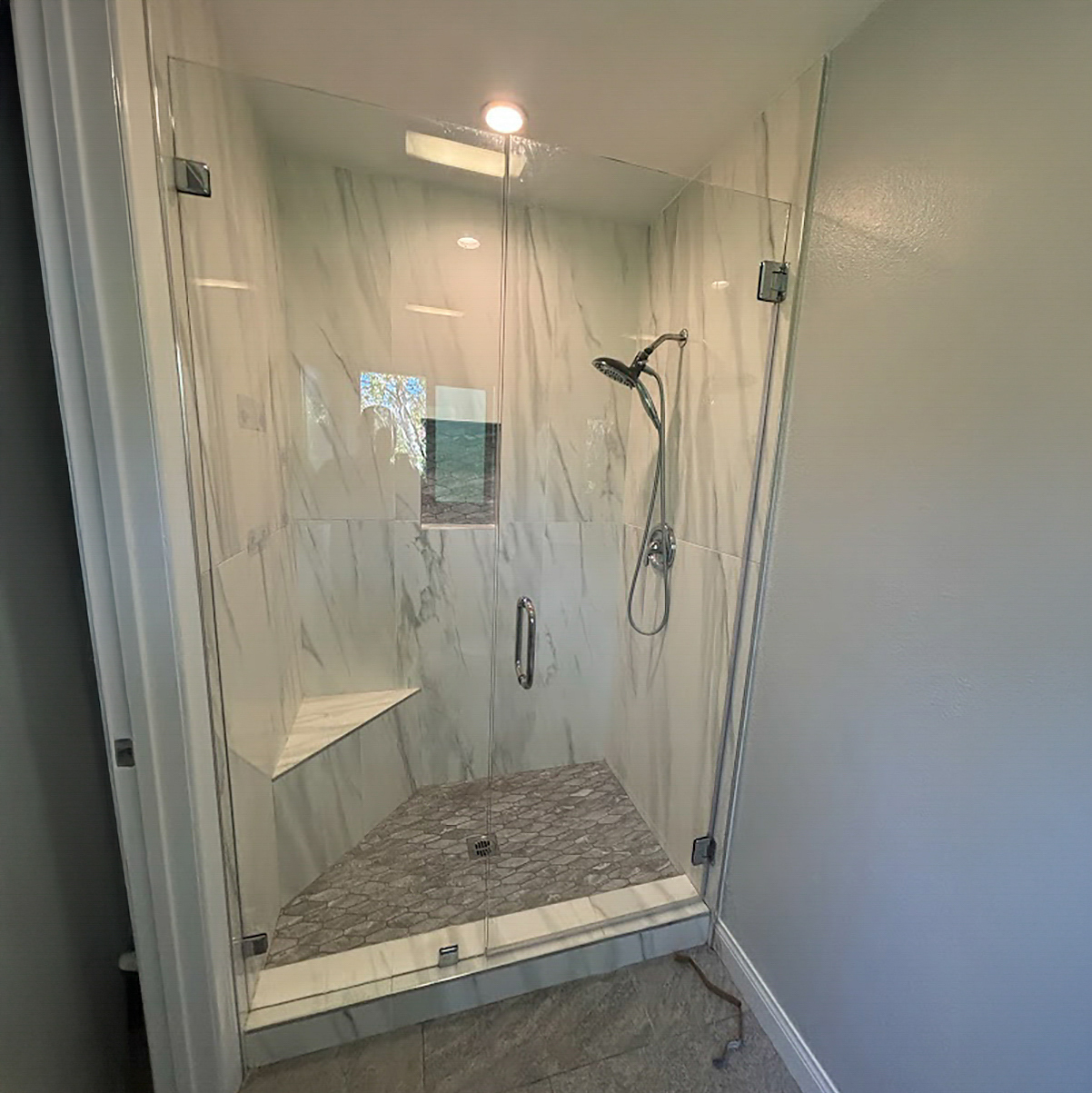 Contemporary walk-in shower design with bench seating for Garden Grove home bathroom remodel