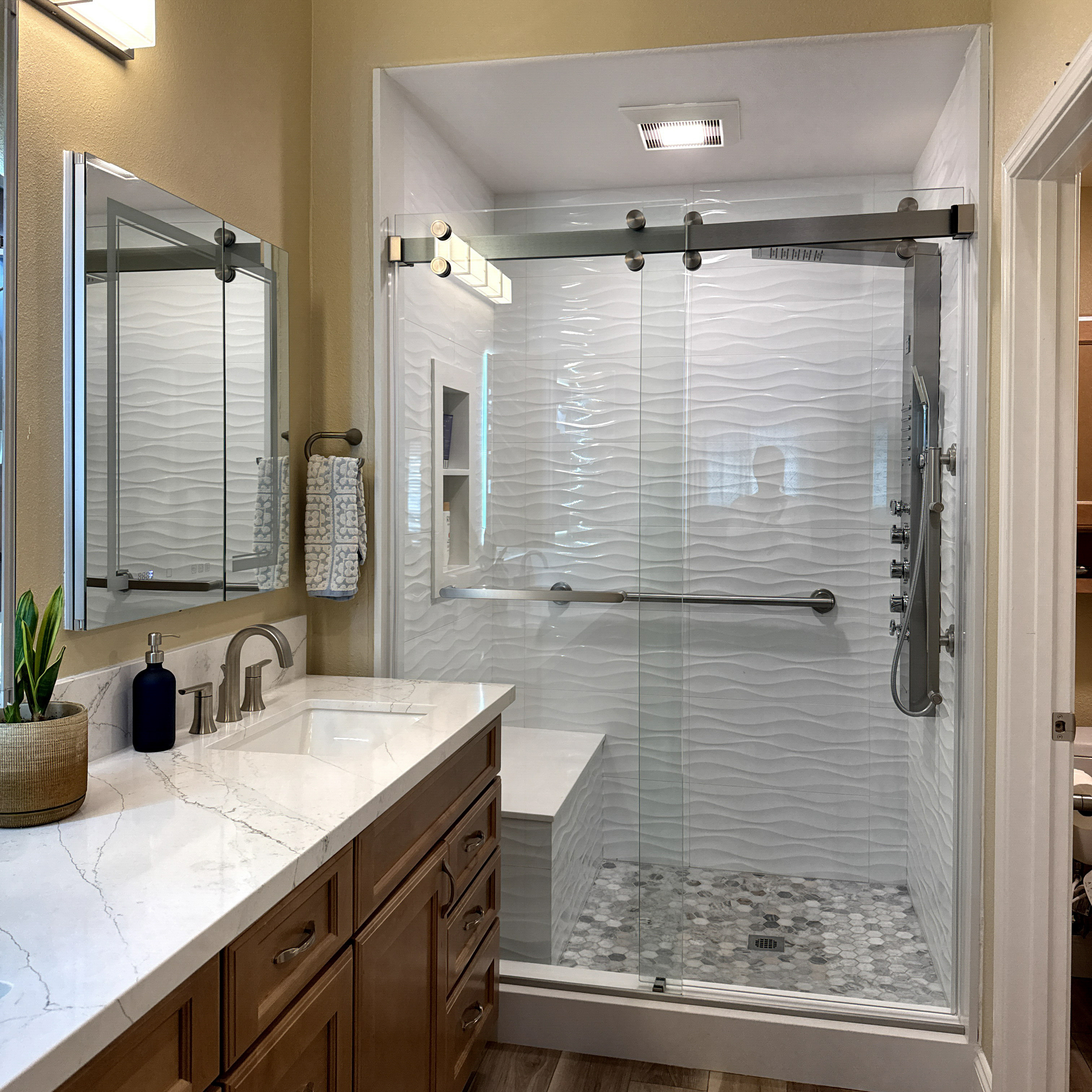 Close-up of upgraded shower fixtures and handheld sprayer in a Lakewood bathroom renovation