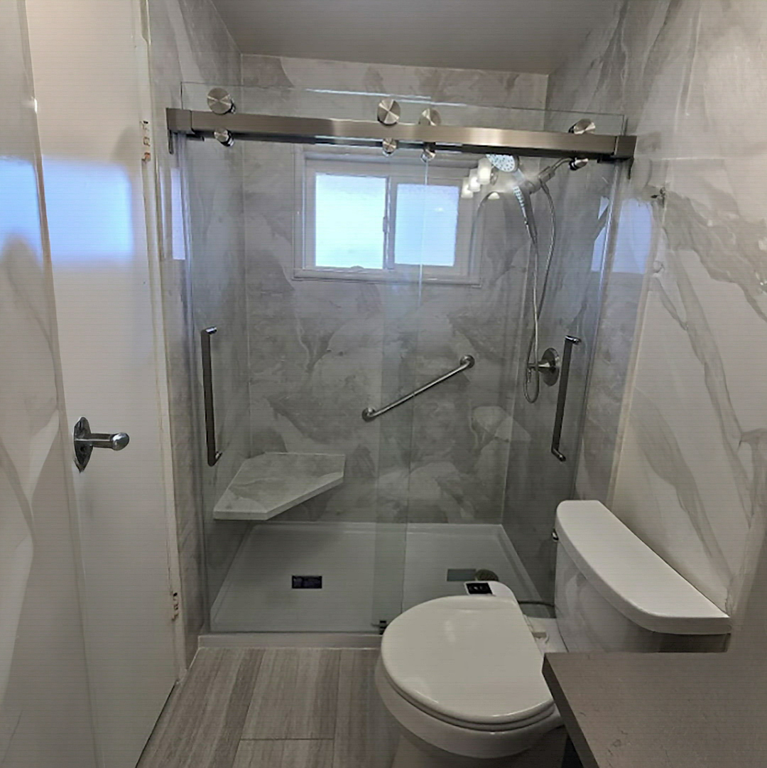 Modern walk-in shower with built-in bench and grab bars by CALbath