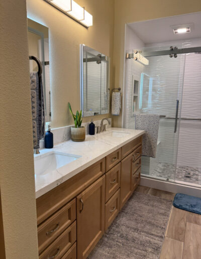 Completed Bellflower bathroom remodel with clean tile work and upgraded lighting