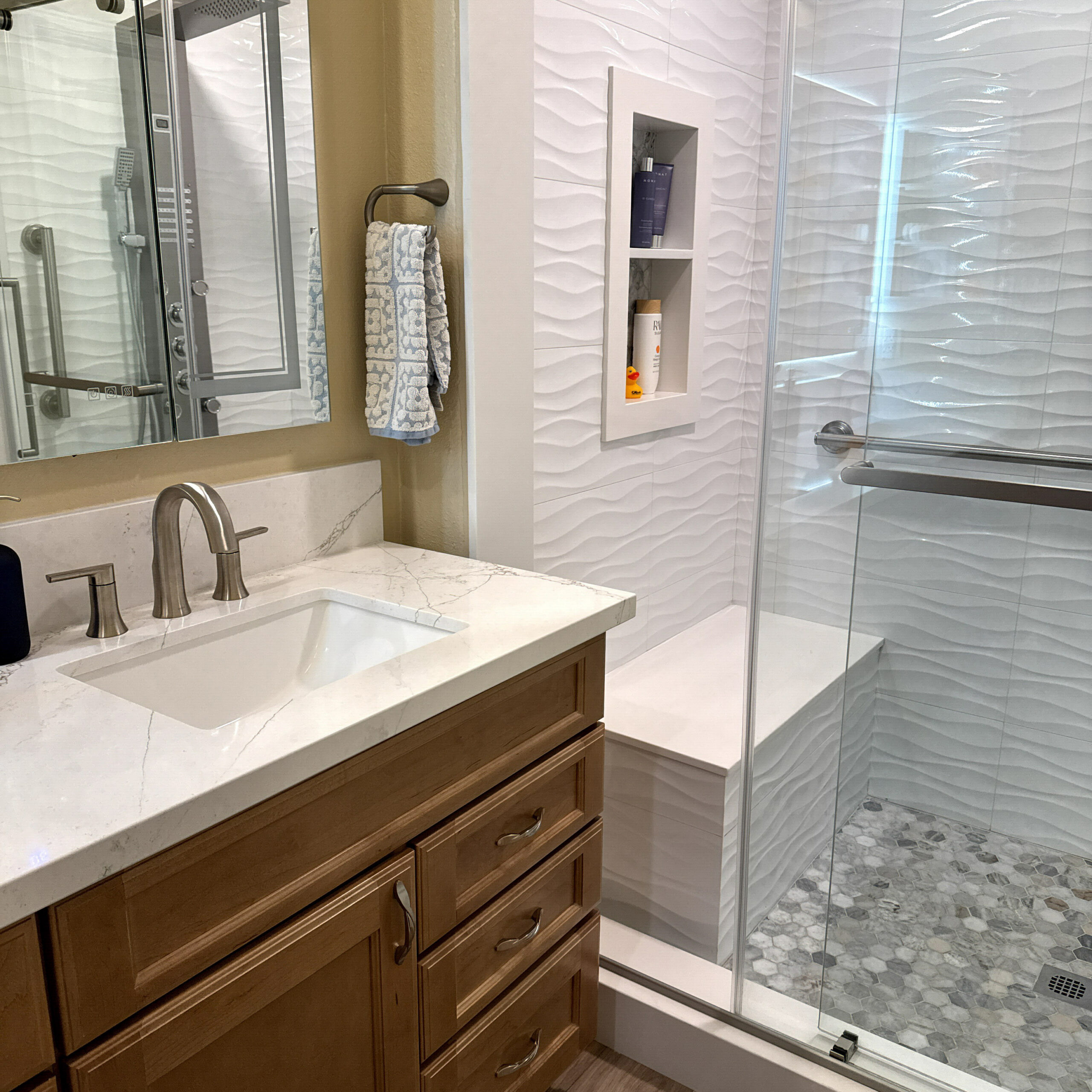Fullerton, CA bathroom renovation with large-format tile flooring and a double vanity by CALbath Renovations