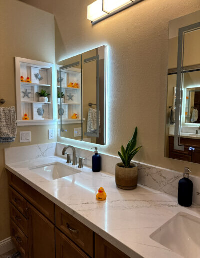 Postwar tract-home bathroom remodel in Fullerton, CA with a modern shower enclosure by CALbath Renovations