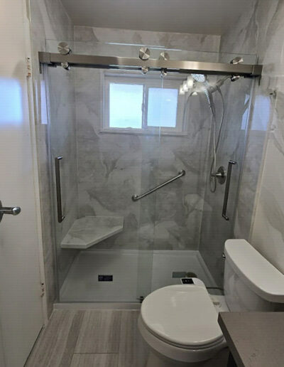Accessible Fullerton walk-in shower with grab bars and a fold-down seat by CALbath Renovations
