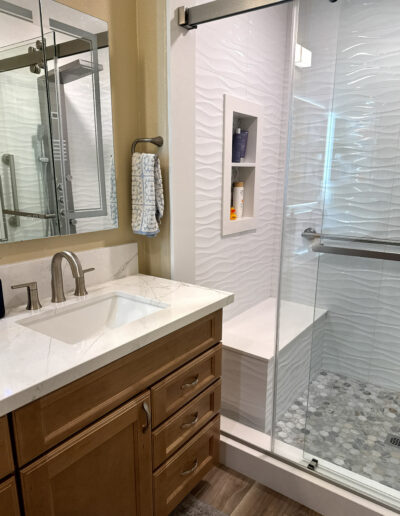 Updated Orange, CA guest bathroom with a glass enclosure and brushed nickel fixtures by CALbath Renovations
