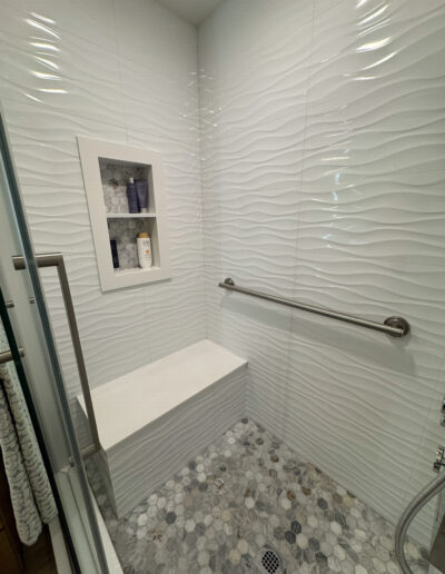 Modern full bathroom remodel in Compton with a freestanding soaking tub, wood-style vanity, and custom tile work by CALbath Renovations.
