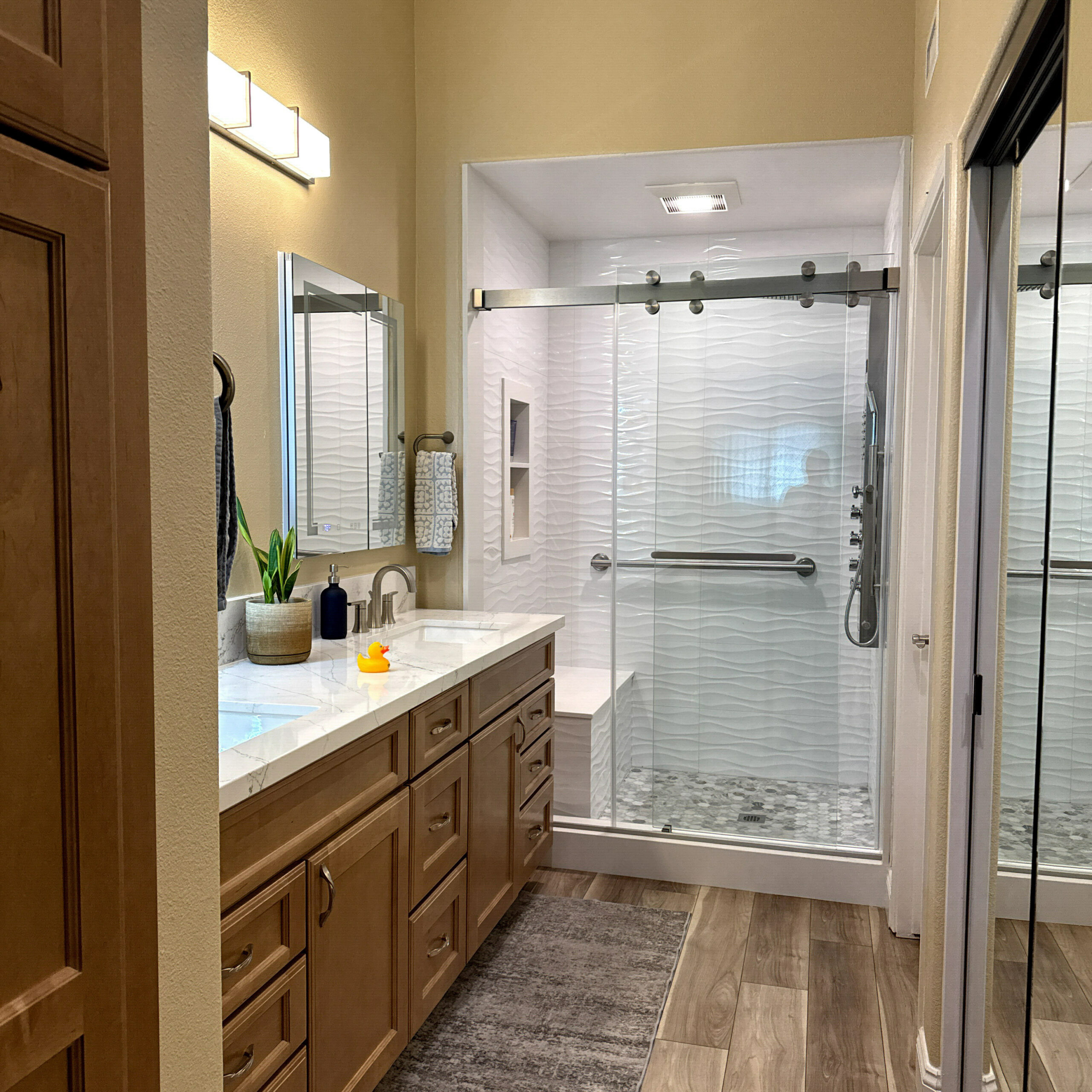 Bright Compton, CA bathroom renovation with white acrylic walls and chrome fixtures by CALbath Renovations