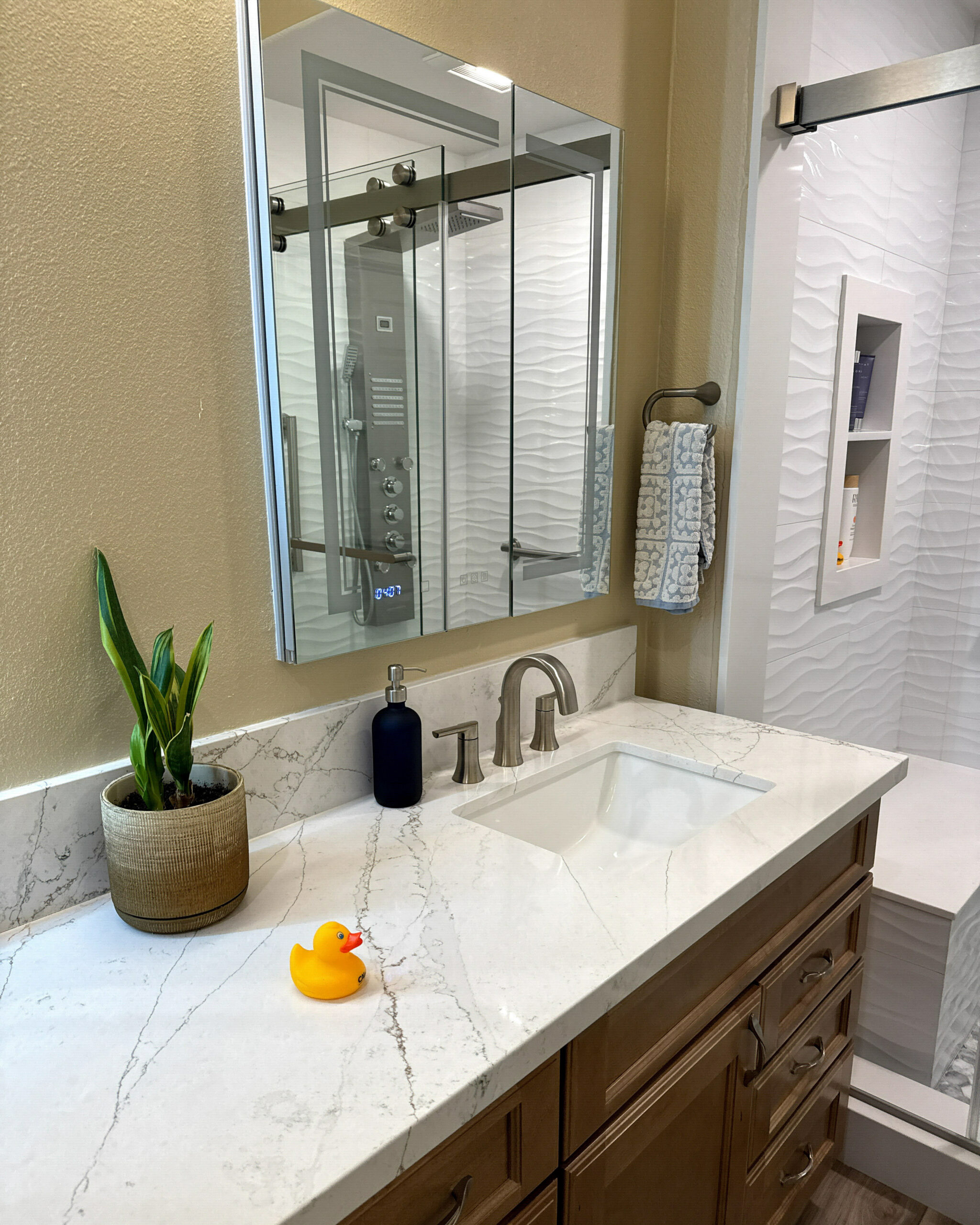 Modern Compton, CA bathroom with brushed nickel hardware and a glass shower door by CALbath Renovations