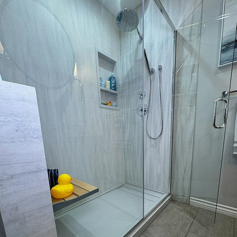 Accessible walk-in shower with grab bars and a fold-down seat by CALbath Renovations