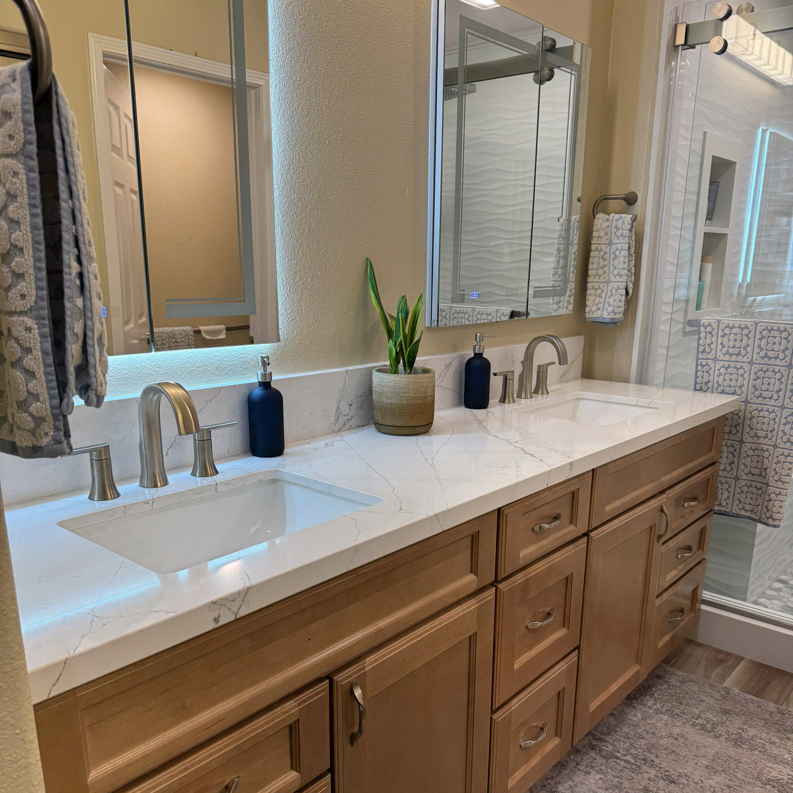Master bathroom remodel with a double vanity and quartz countertop by CALbath Renovations