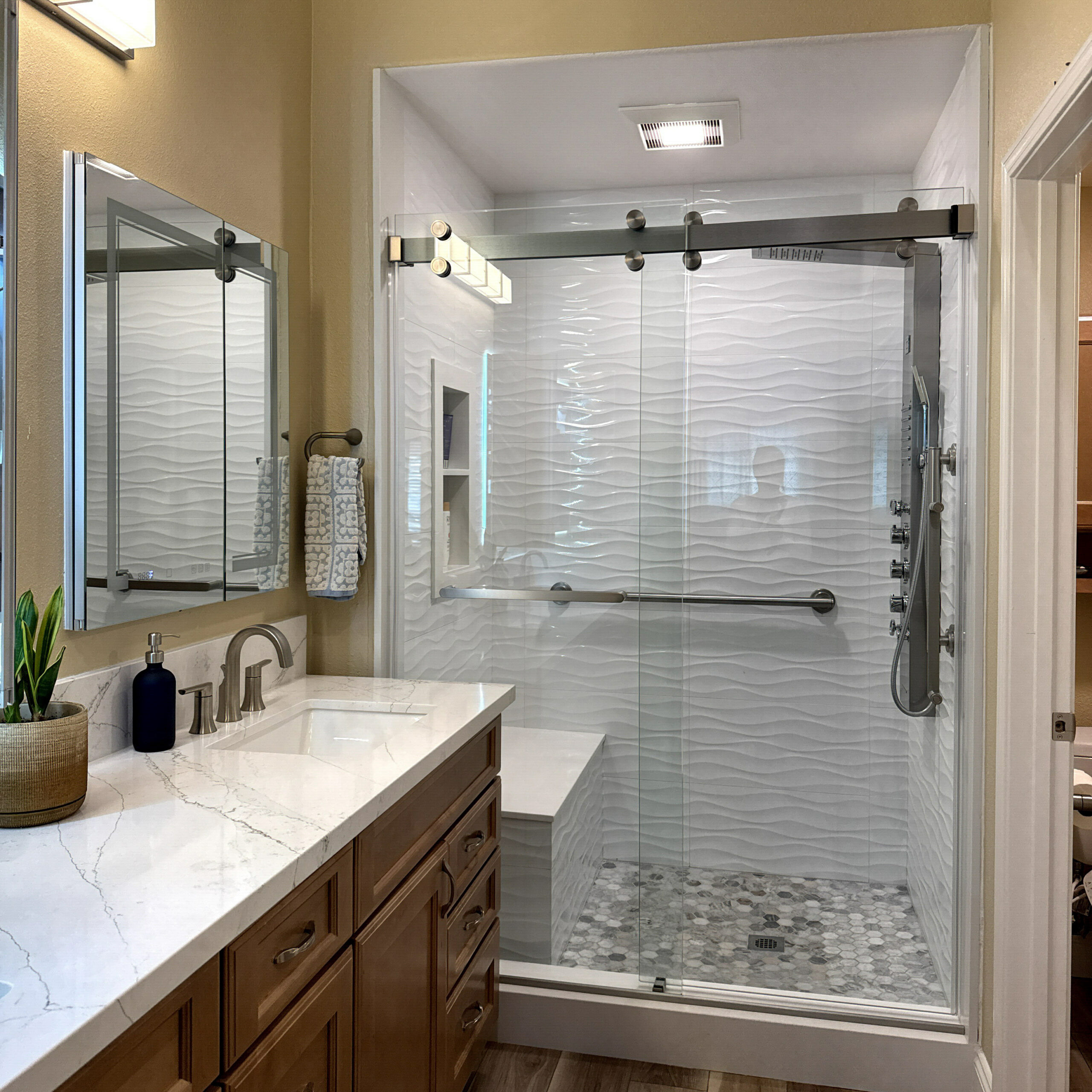 Updated guest bathroom with a frameless glass shower enclosure by CALbath Renovations