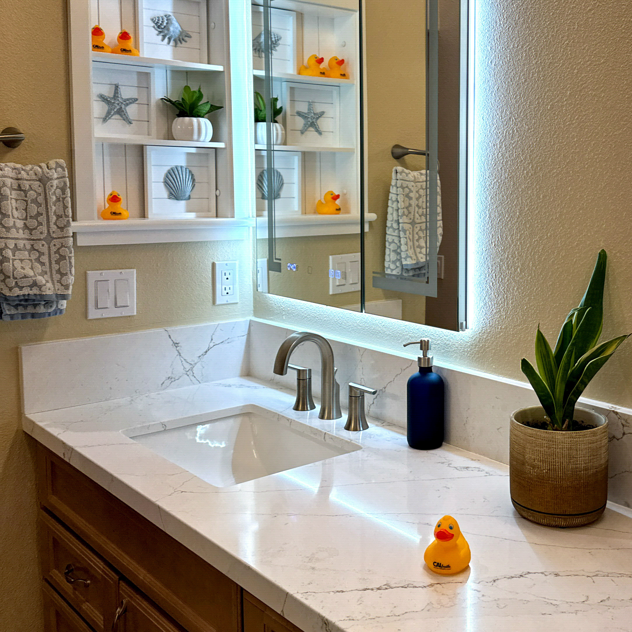 Transitional bathroom renovation with custom cabinetry and undermount sinks by CALbath Renovations