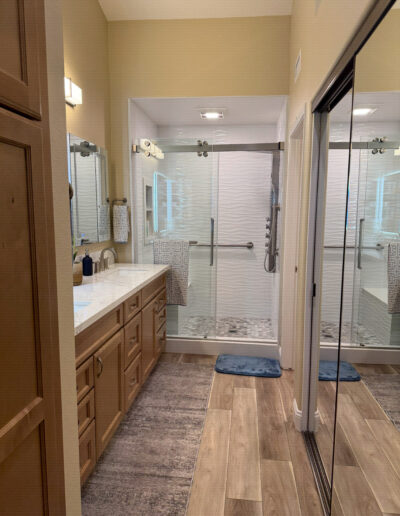 Full bathroom remodel with a walk-in shower and floating vanity by CALbath Renovations