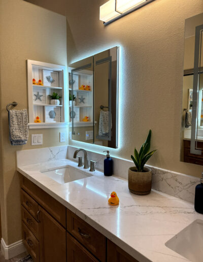 Modern full bathroom remodel in Redondo Beach with a freestanding soaking tub, wood-style vanity, and custom tile work by CALbath Renovations.