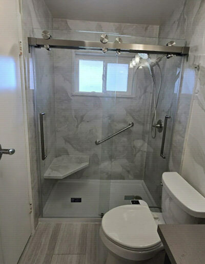 Whittier, CA bathroom remodel with brushed nickel fixtures and a glass shower door by CALbath Renovations